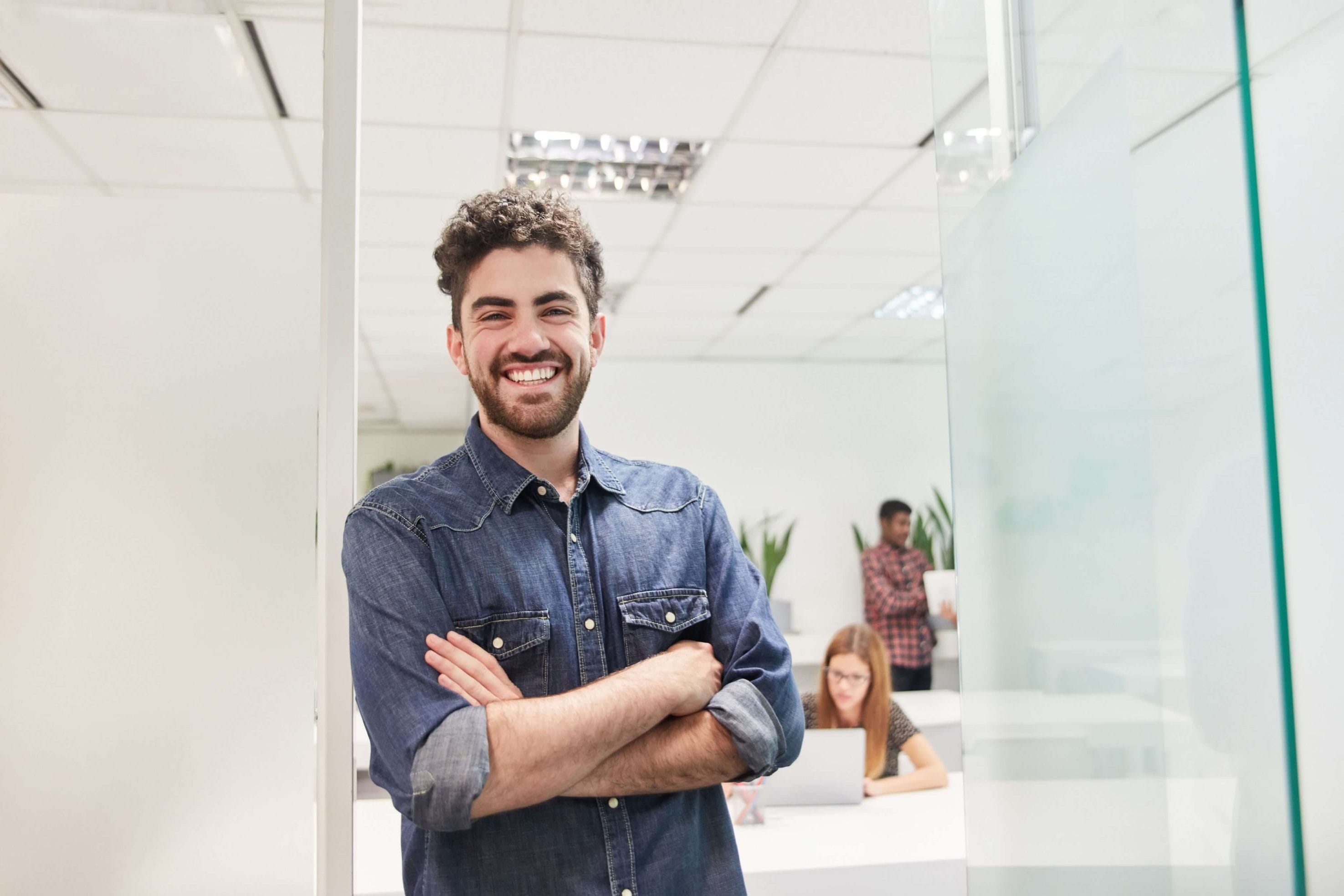 Man Smiling in Office Related to Radon Services
