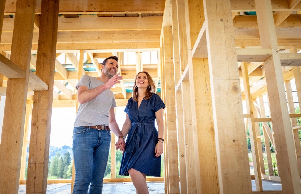 Couple inspecting radon mitigation in new home construction